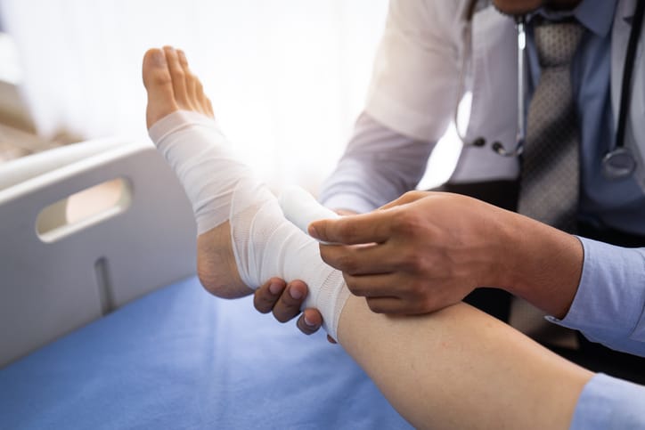 Photo shows a doctor wrapping a patient's foot/Getty Images
