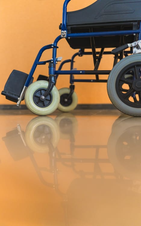 Photo shows an empty wheelchair parked in a hallway/Getty Images