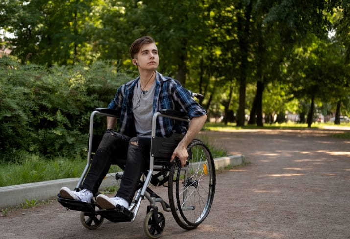 Photo of teen in wheelchair at a park