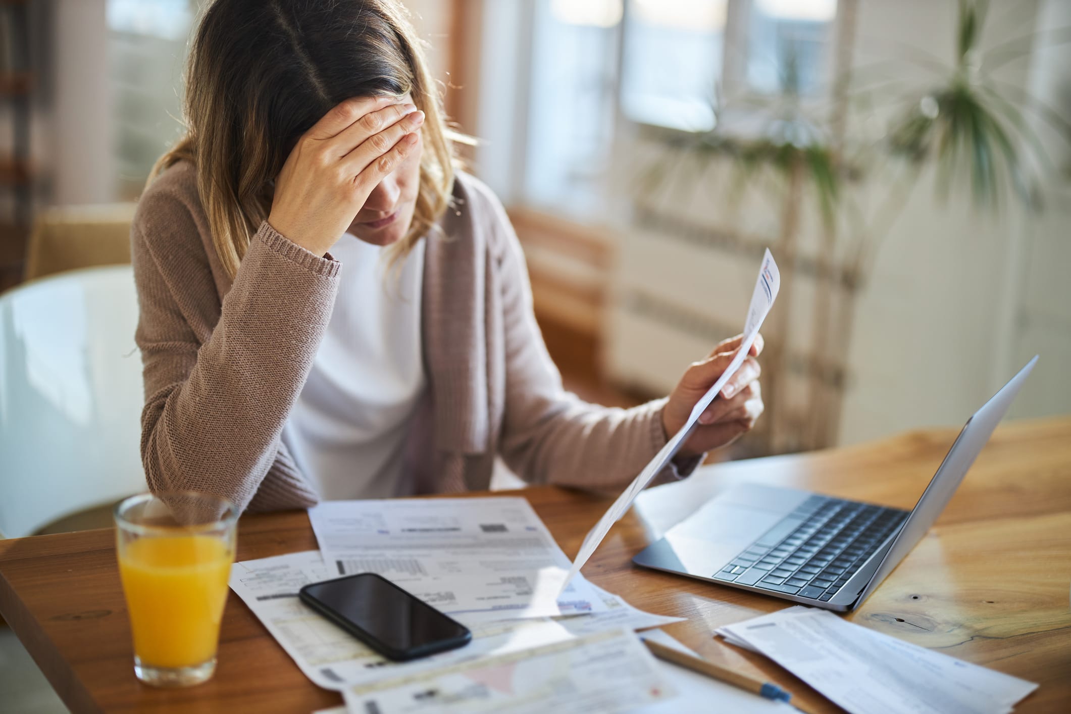 Woman having problems with her bills at home.