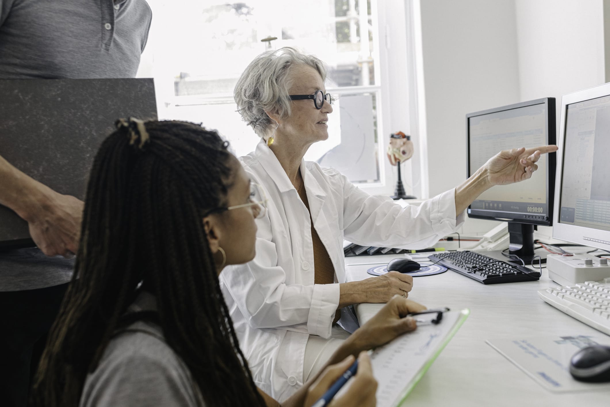 Medical researches examining data on a monitor