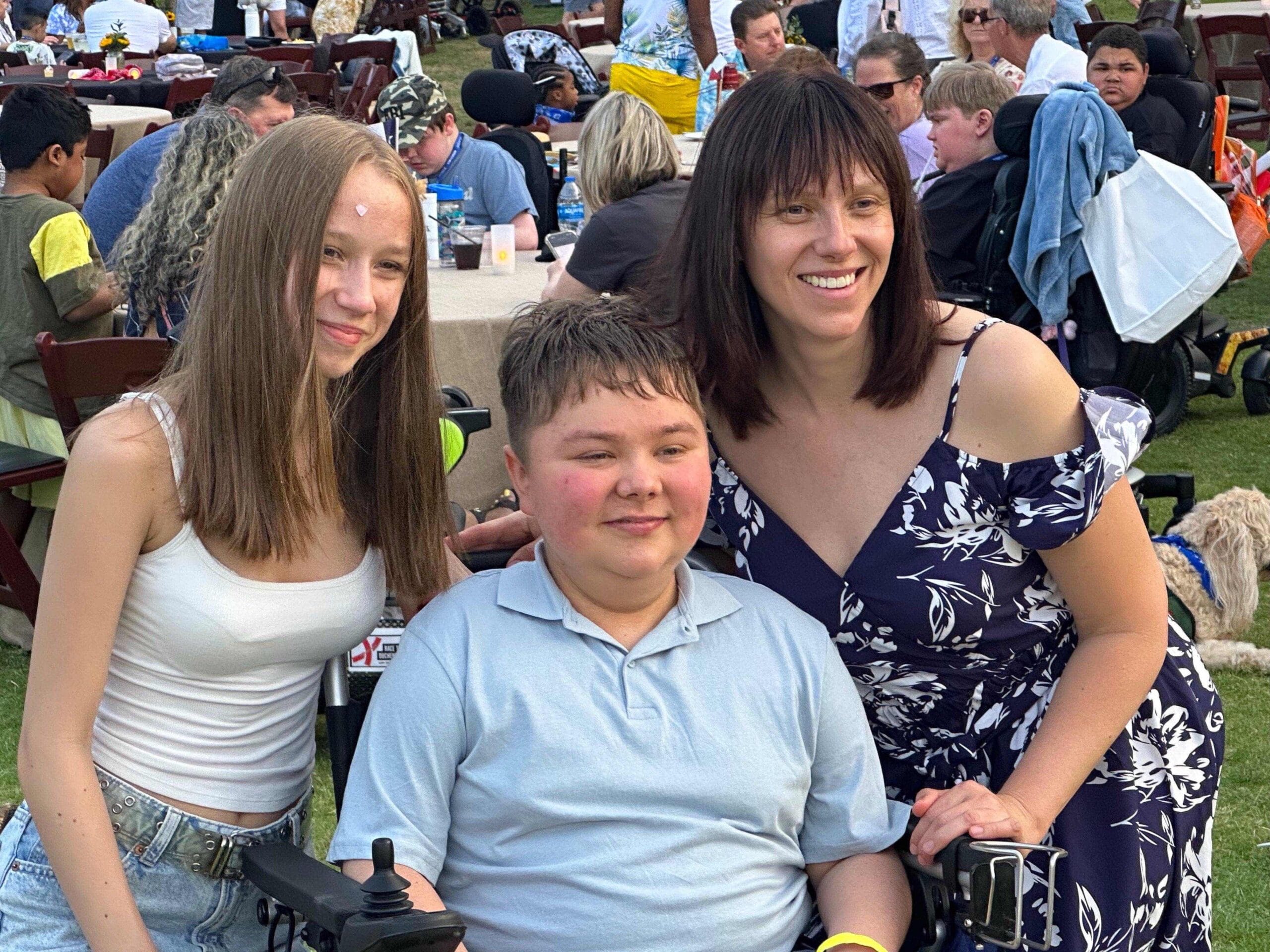 Mykhailo "Misha" Yelizarov at CureDuchenne's 2025 Futures conference in San Antonio, Texas, along with his sister, Anna Yelizarova, and his mother, Nadia Yelizarova