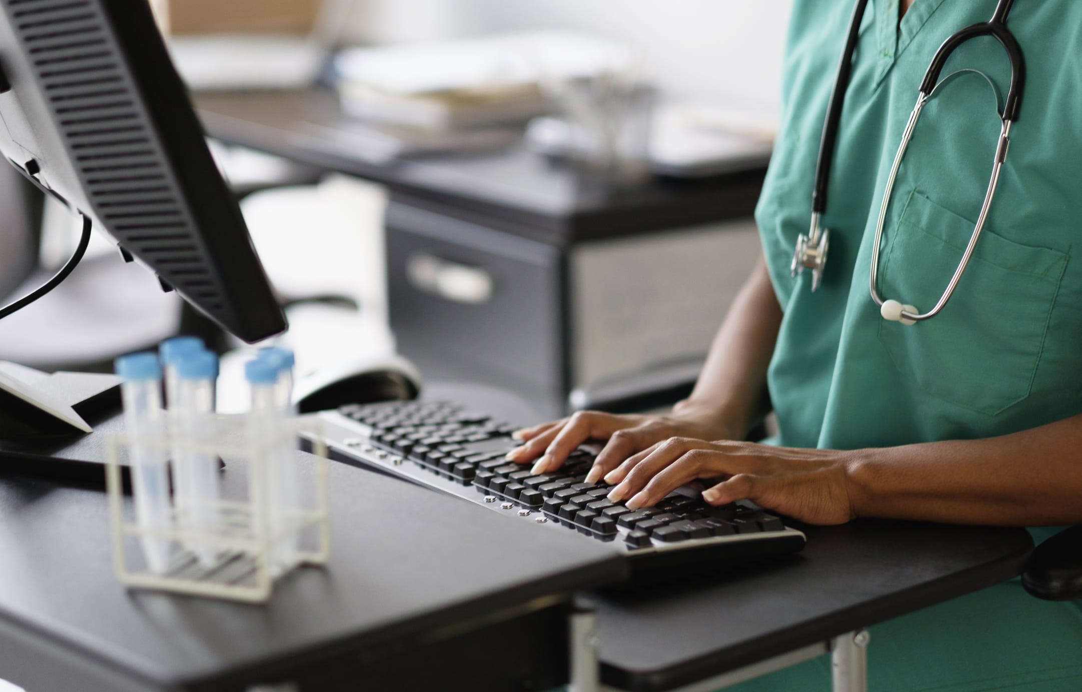 Healthcare provider working at a computer