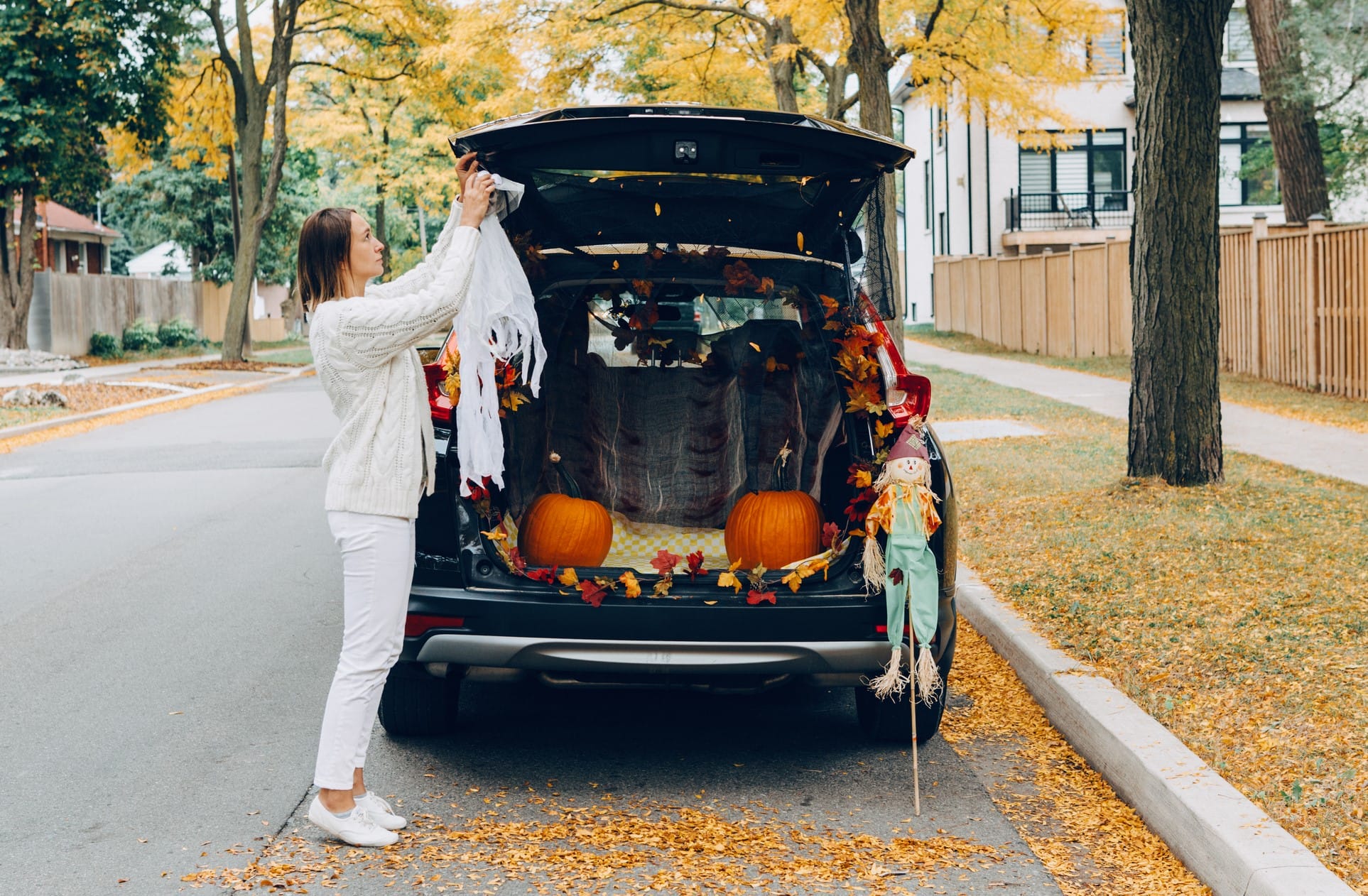 Mother decorating van for trunk-or-treat