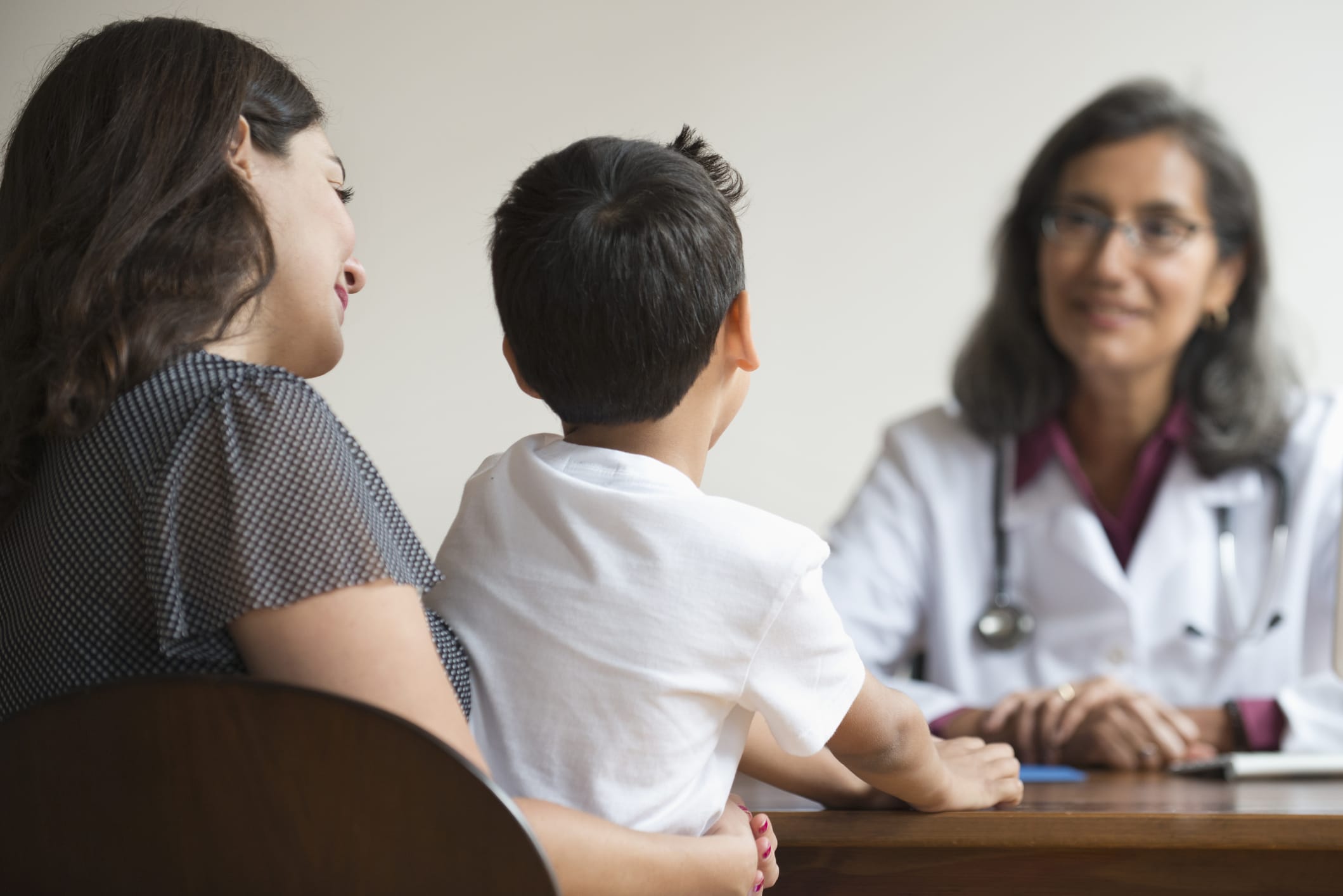 Mixed Race doctor talking with patients